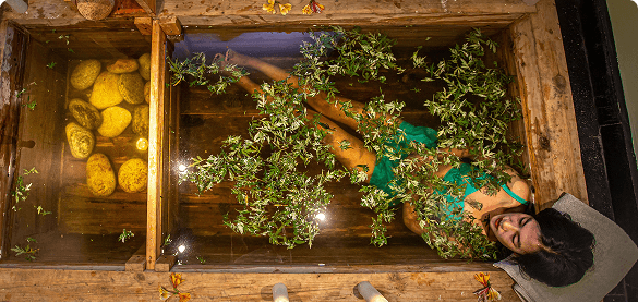 A guest resting in a herbal hot-stone bath